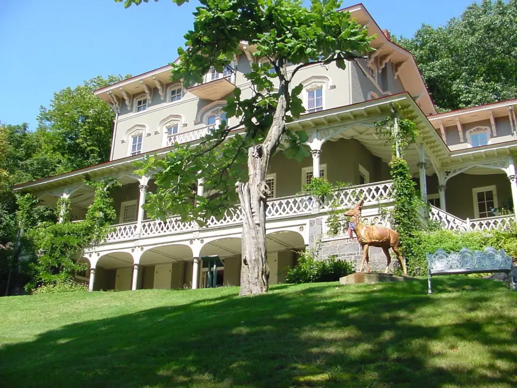 The cream-colored Asa Packer Mansion with its wraparound porch on a hillside above Jim Thorpe