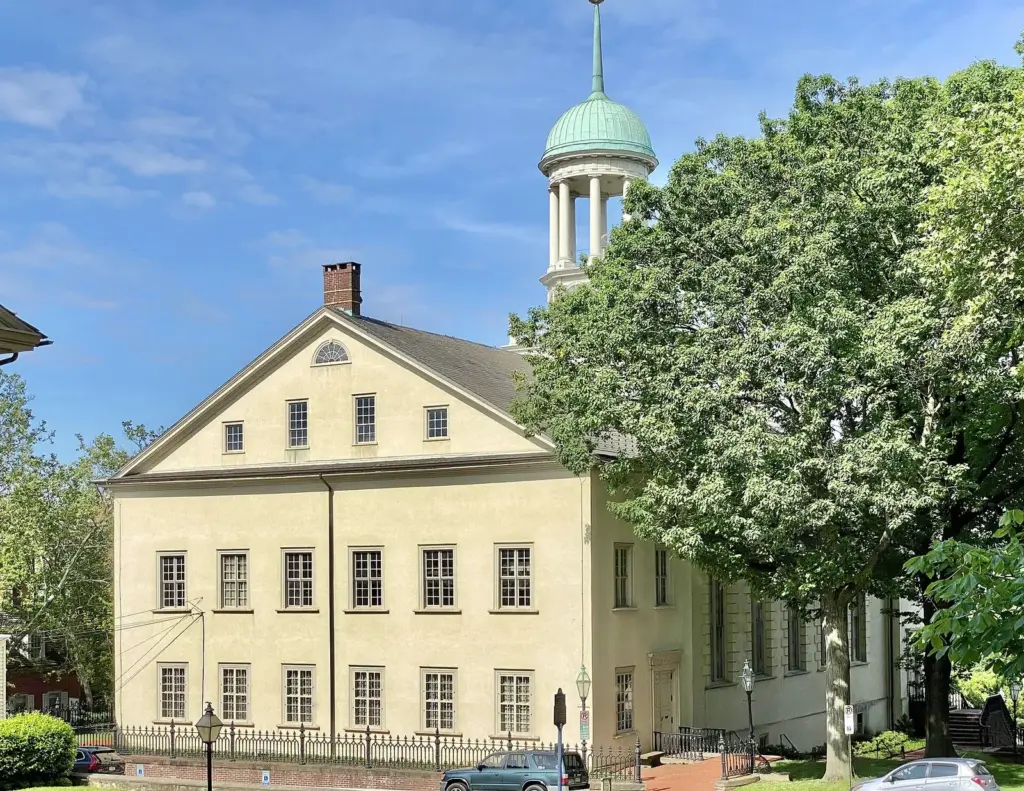 Central Moravian Church's pale stucco facade and domed belfry on Main Street in Bethlehem