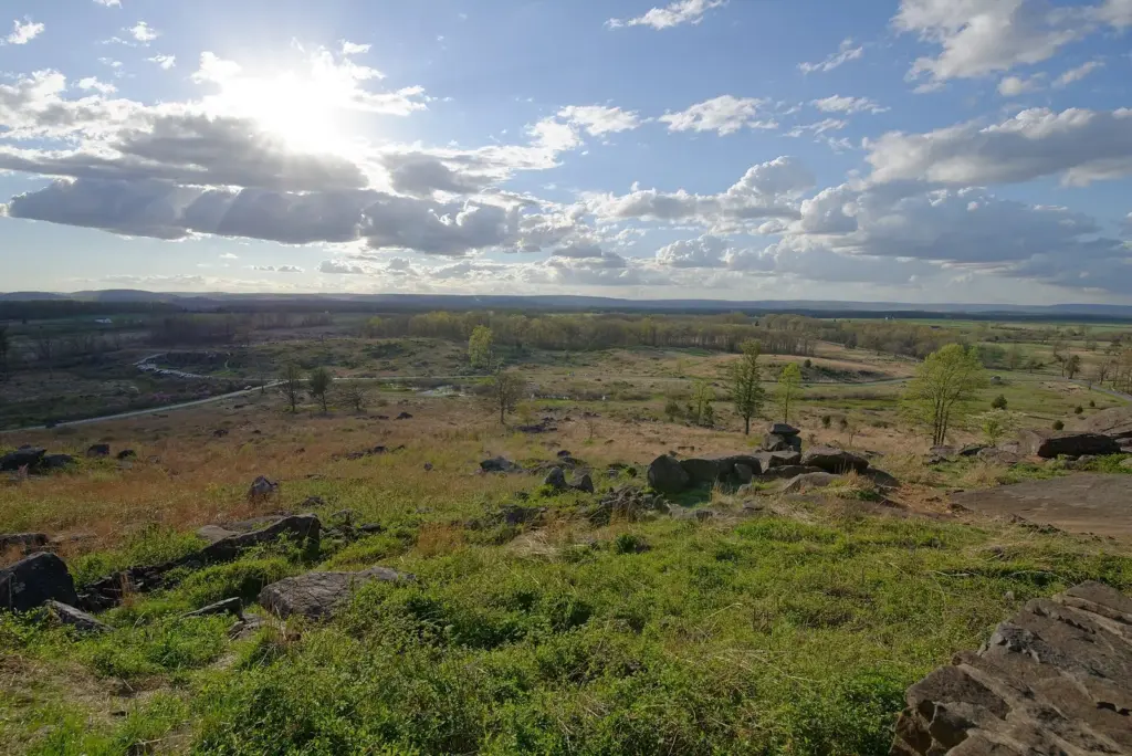The boulders of Devil's Den and the open fields beyond, seen from Little Round Top at Gettysburg