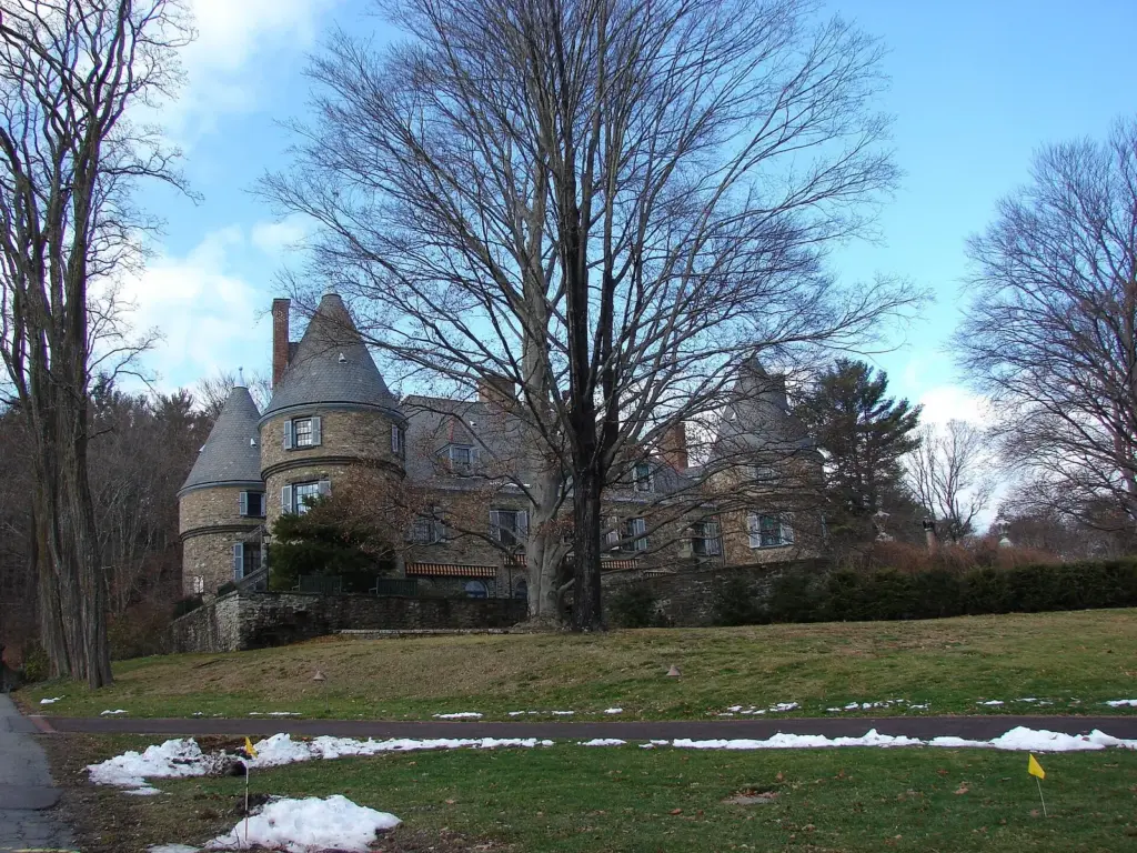 The turreted stone front of Grey Towers, Gifford Pinchot's home near Milford, behind bare winter trees