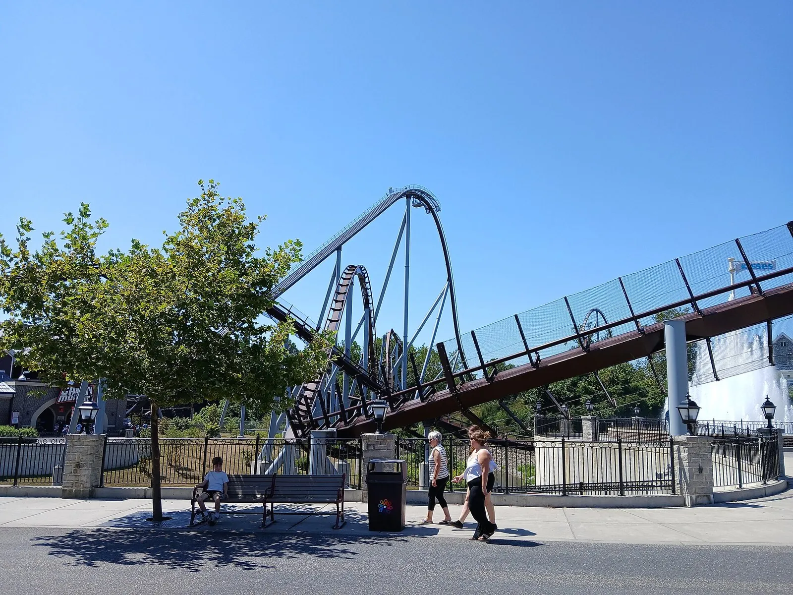 Candymonium's steel coaster track curving against a blue summer sky at Hersheypark, the centerpiece of a Hershey PA vacation