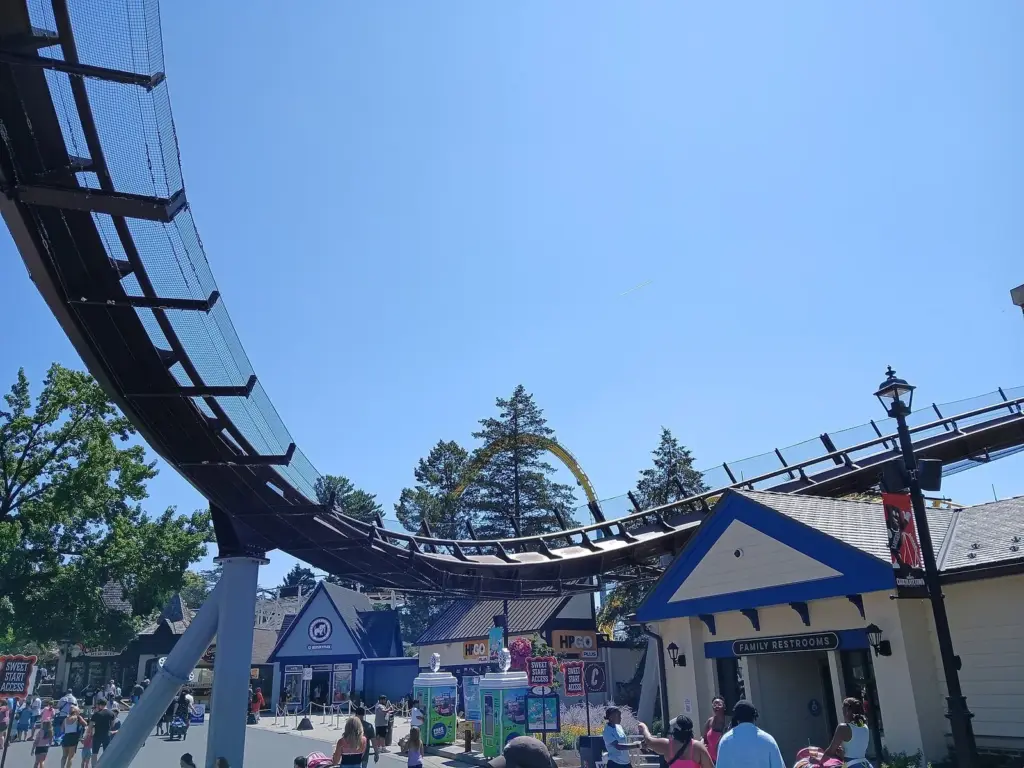 Candymonium's track passing over a Hersheypark plaza lined with candy-themed buildings