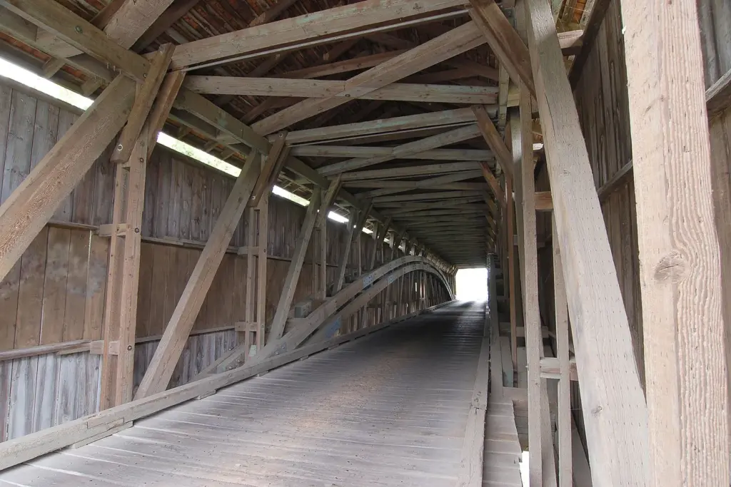 The timber trusses and plank floor inside Hunsecker's Mill Covered Bridge