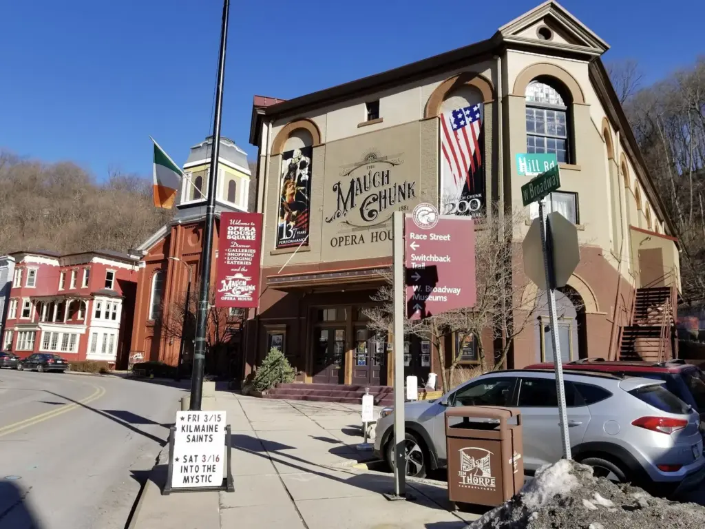 The Mauch Chunk Opera House and brick storefronts on a sloping street in Jim Thorpe