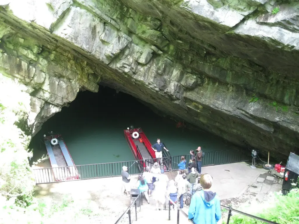 Stairs leading down to the boat landing at the mouth of Penn's Cave, with tour boats waiting inside