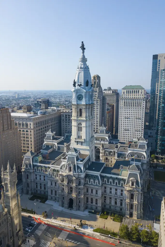 Philadelphia City Hall's ornate stone tower topped by the William Penn statue among Center City towers