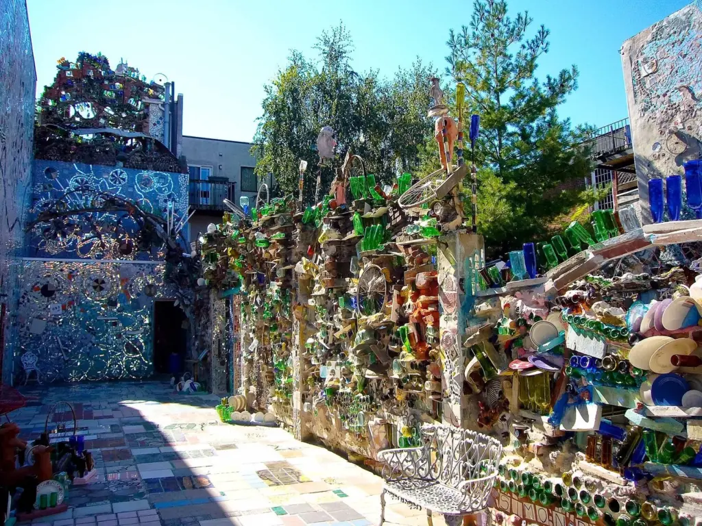 Walls and walkways covered in mosaic tile, mirror and bottles at Philadelphia's Magic Gardens