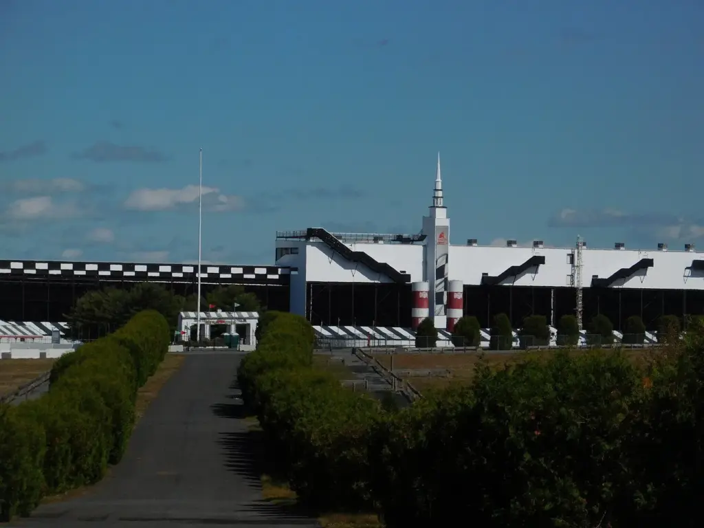 The grandstands and a rocket-shaped tower at Pocono Raceway under a blue sky