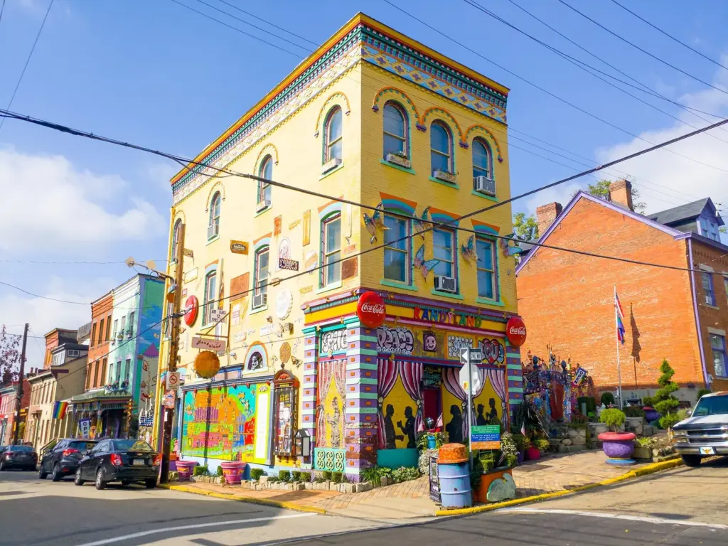 Randyland's corner building painted in bright yellows, reds and blues on a sunny day