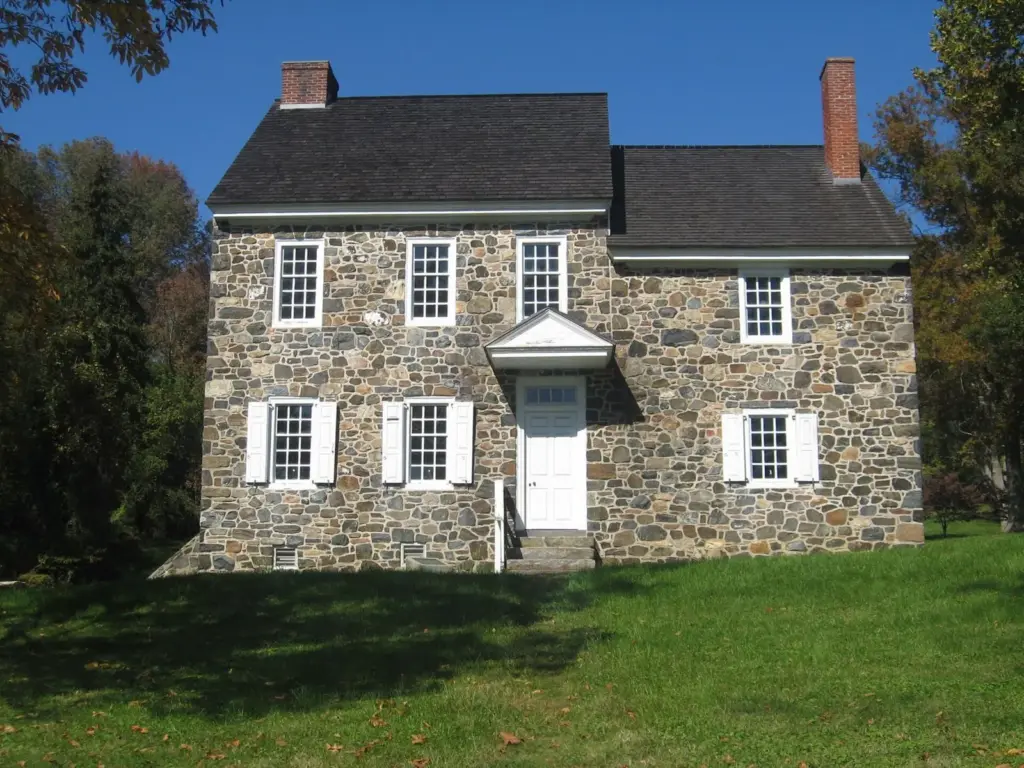 Two-story fieldstone farmhouse with white shutters at Brandywine Battlefield Park