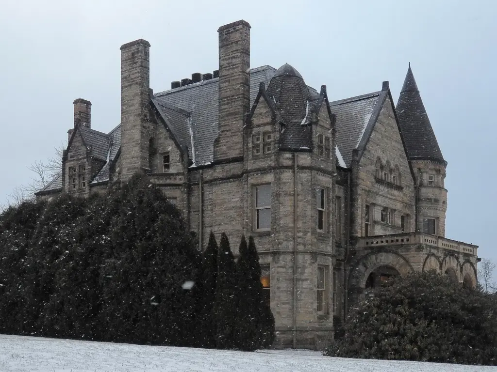 The turreted gray stone Buhl Mansion in Sharon on a snowy evening