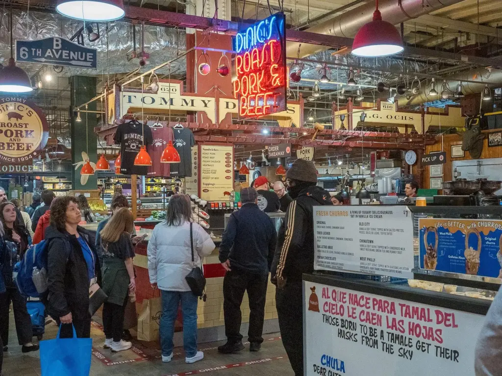 DiNic's Roast Pork and Beef counter with its red neon sign inside Reading Terminal Market