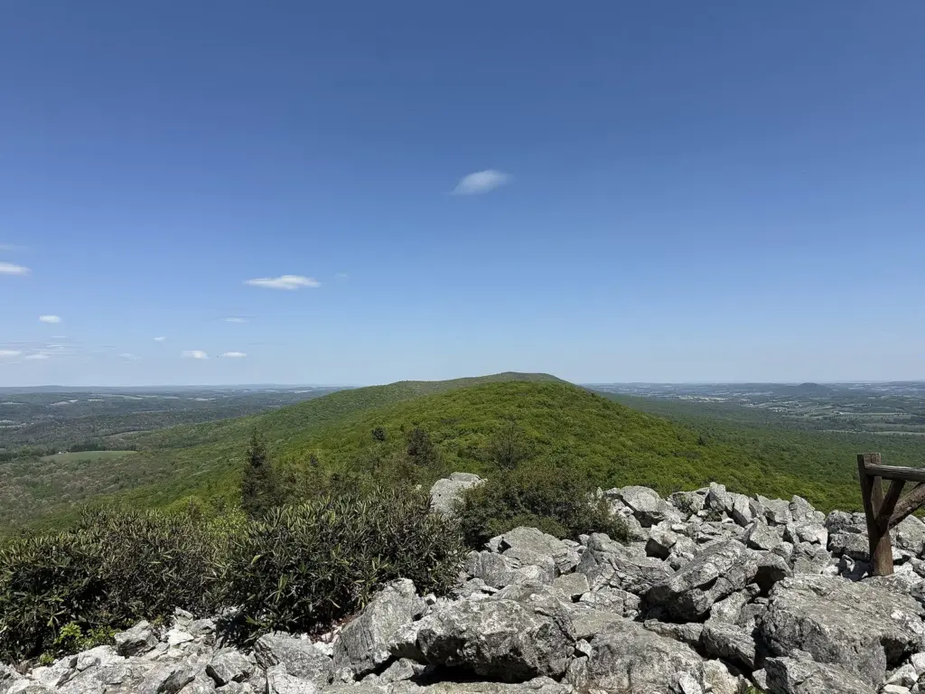 Boulders at Hawk Mountain's North Lookout above forested ridges and farmland