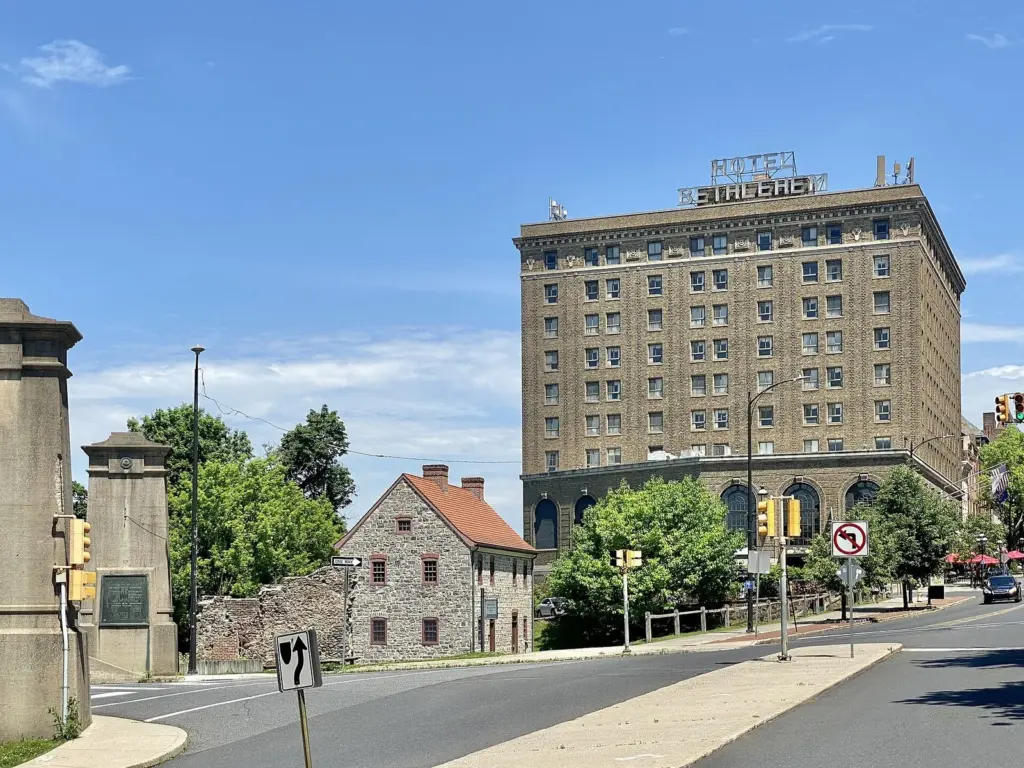 The tall brick Hotel Bethlehem rising above stone buildings at the top of Main Street