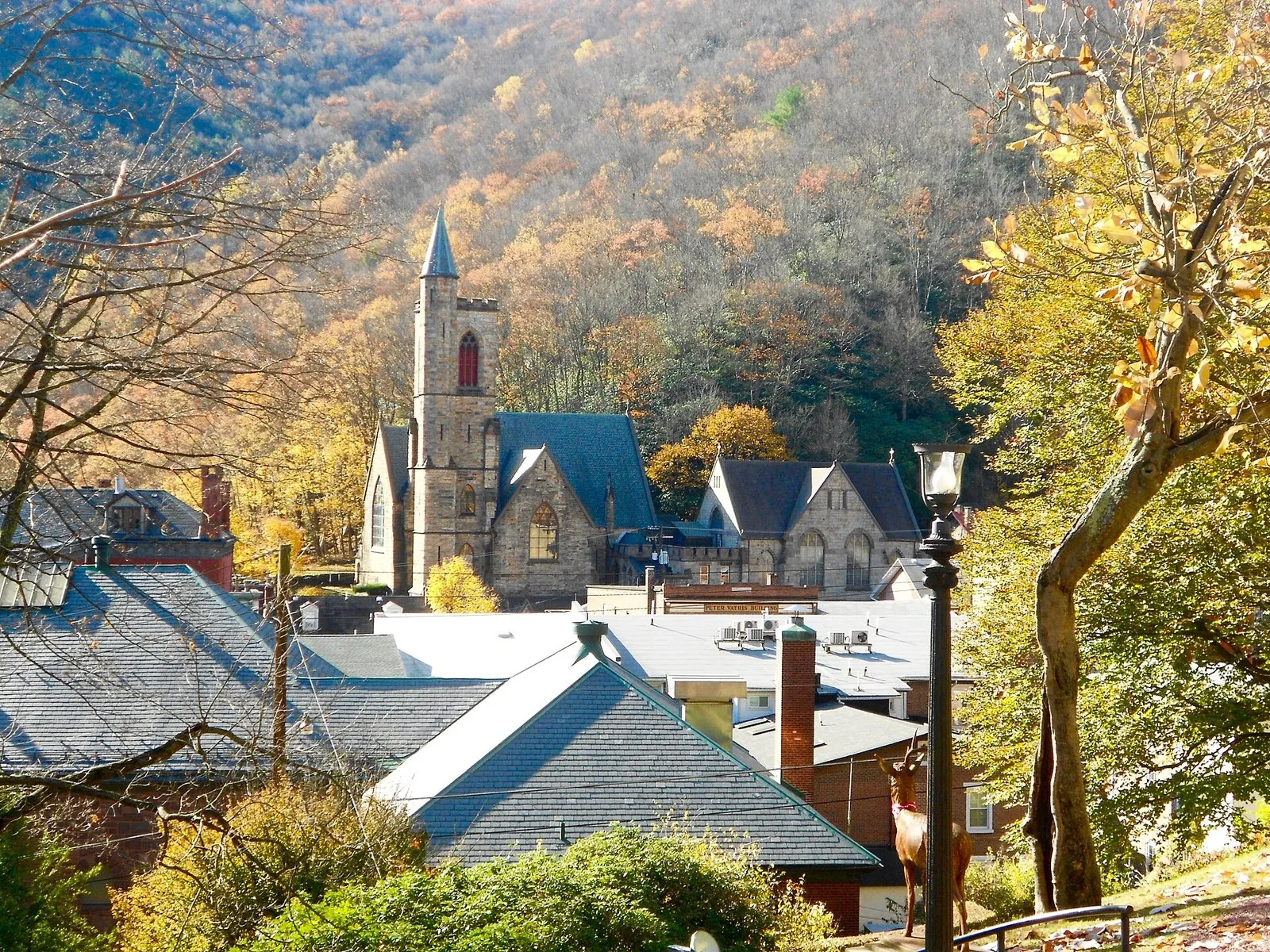 Jim Thorpe's stone church and rooftops below hills in fall color, one of the classic weekend getaways in Pennsylvania