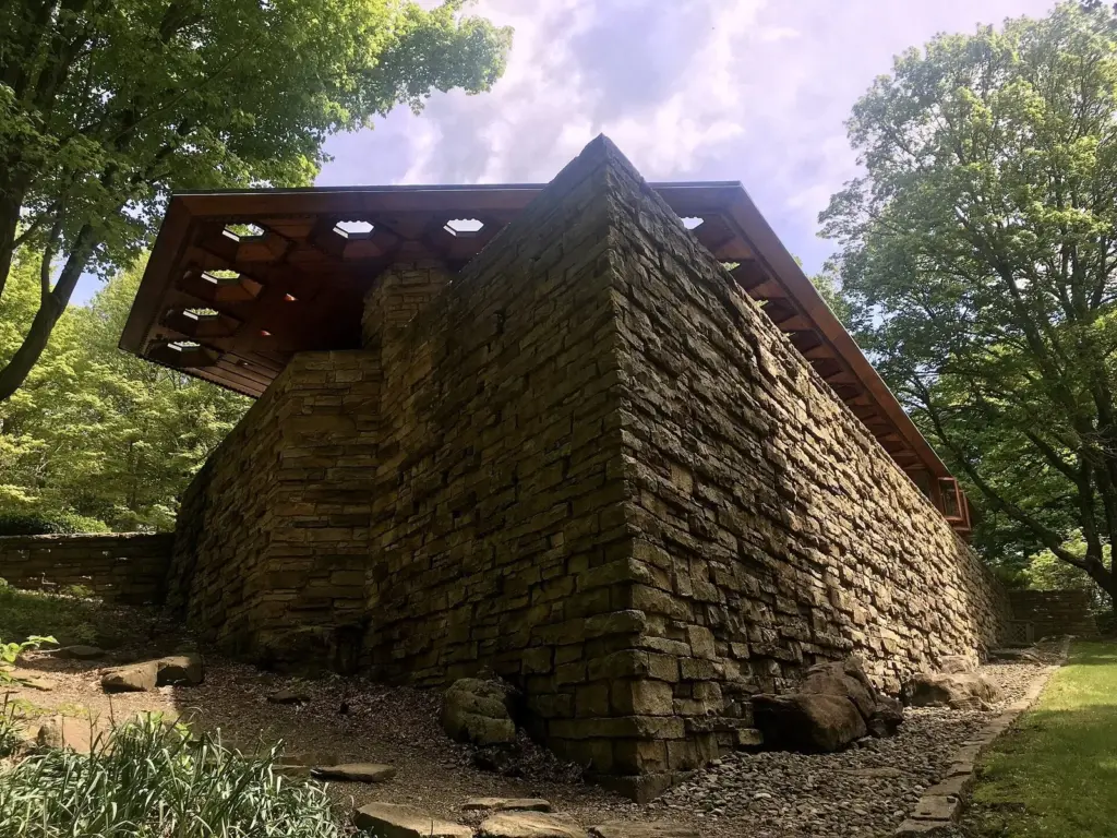 The sharp stone prow of Kentuck Knob under its overhanging roof among trees