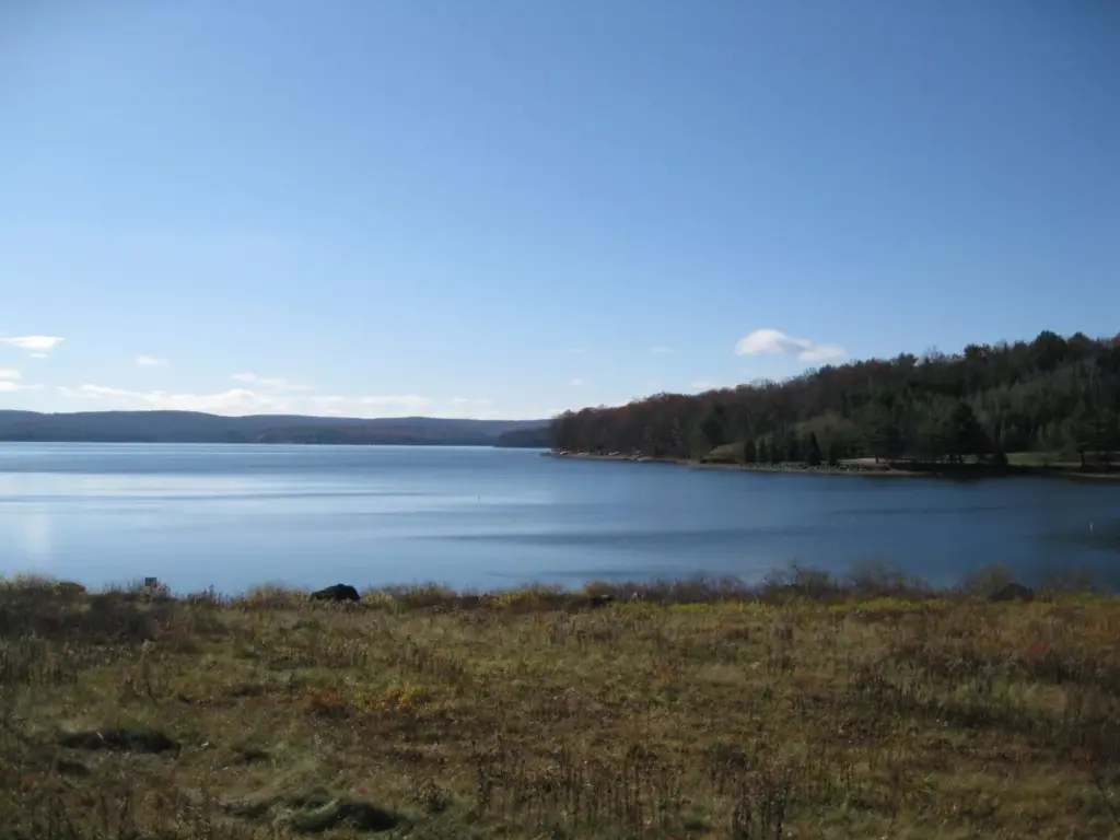 Calm blue water of Lake Wallenpaupack with wooded hills on the far shore