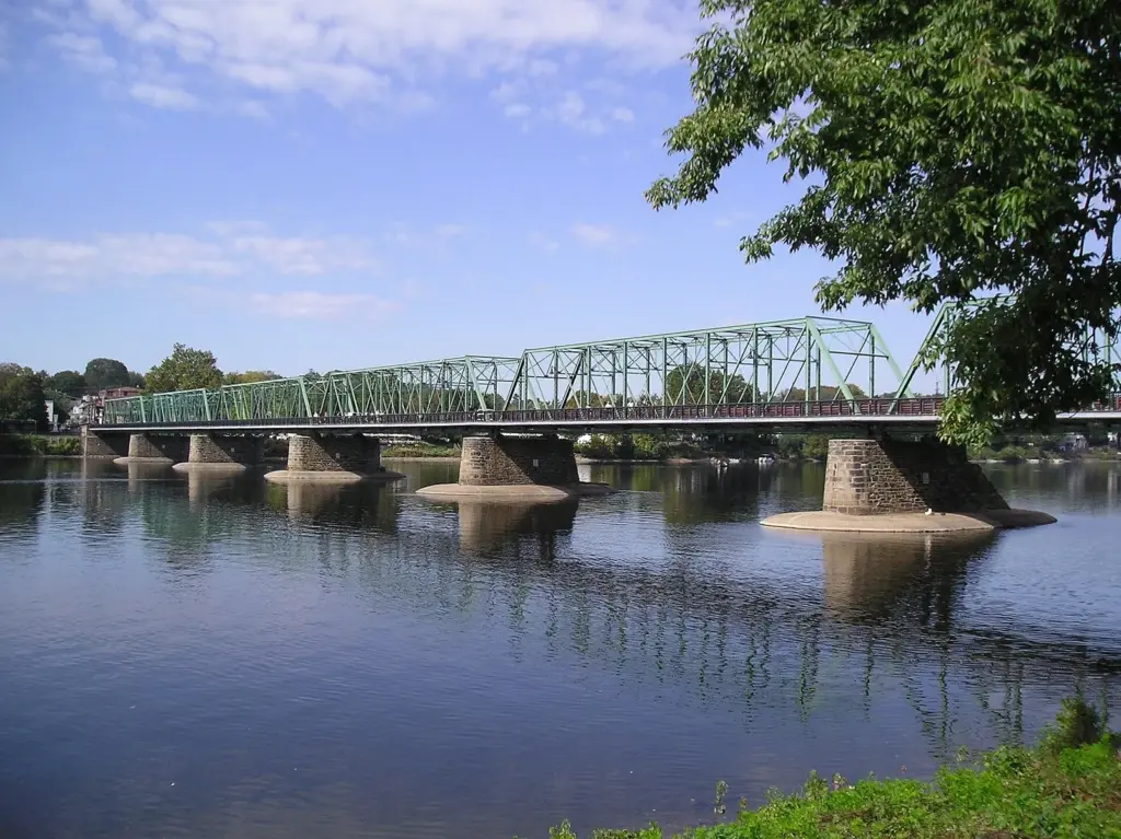 The green steel truss bridge between New Hope and Lambertville reflected in the Delaware River