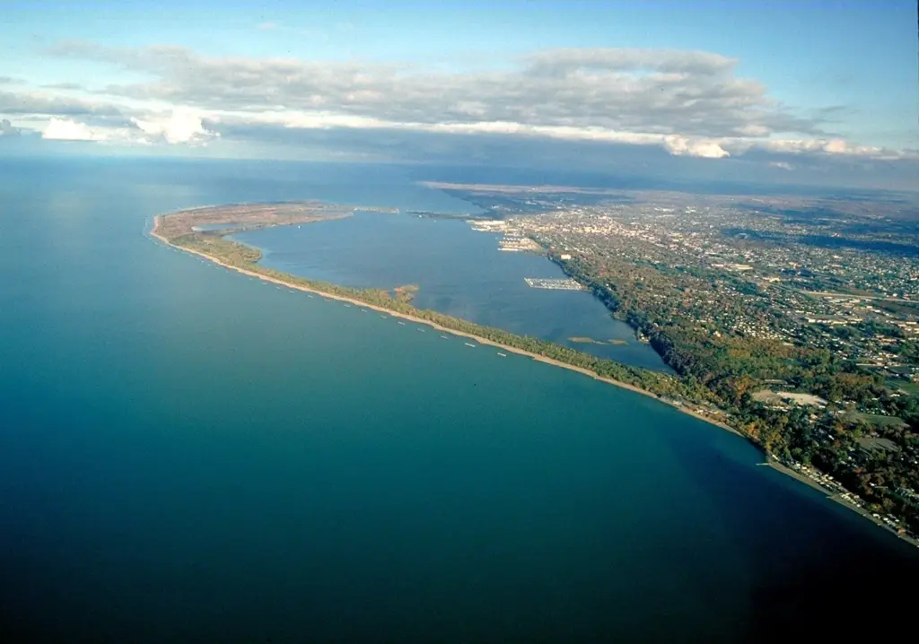 Aerial view of the curving Presque Isle peninsula and its breakwaters on Lake Erie