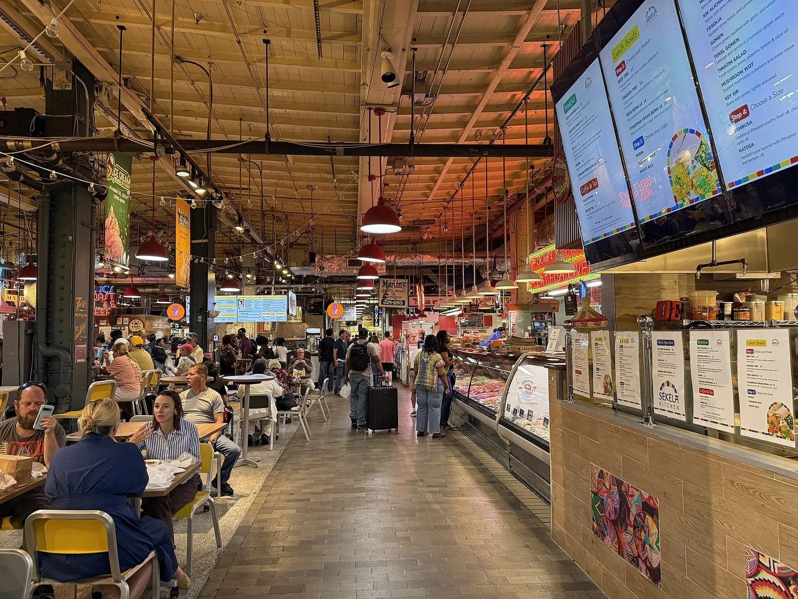 Food counters, menu boards and shared seating inside Reading Terminal Market, the busiest hub of Philadelphia food