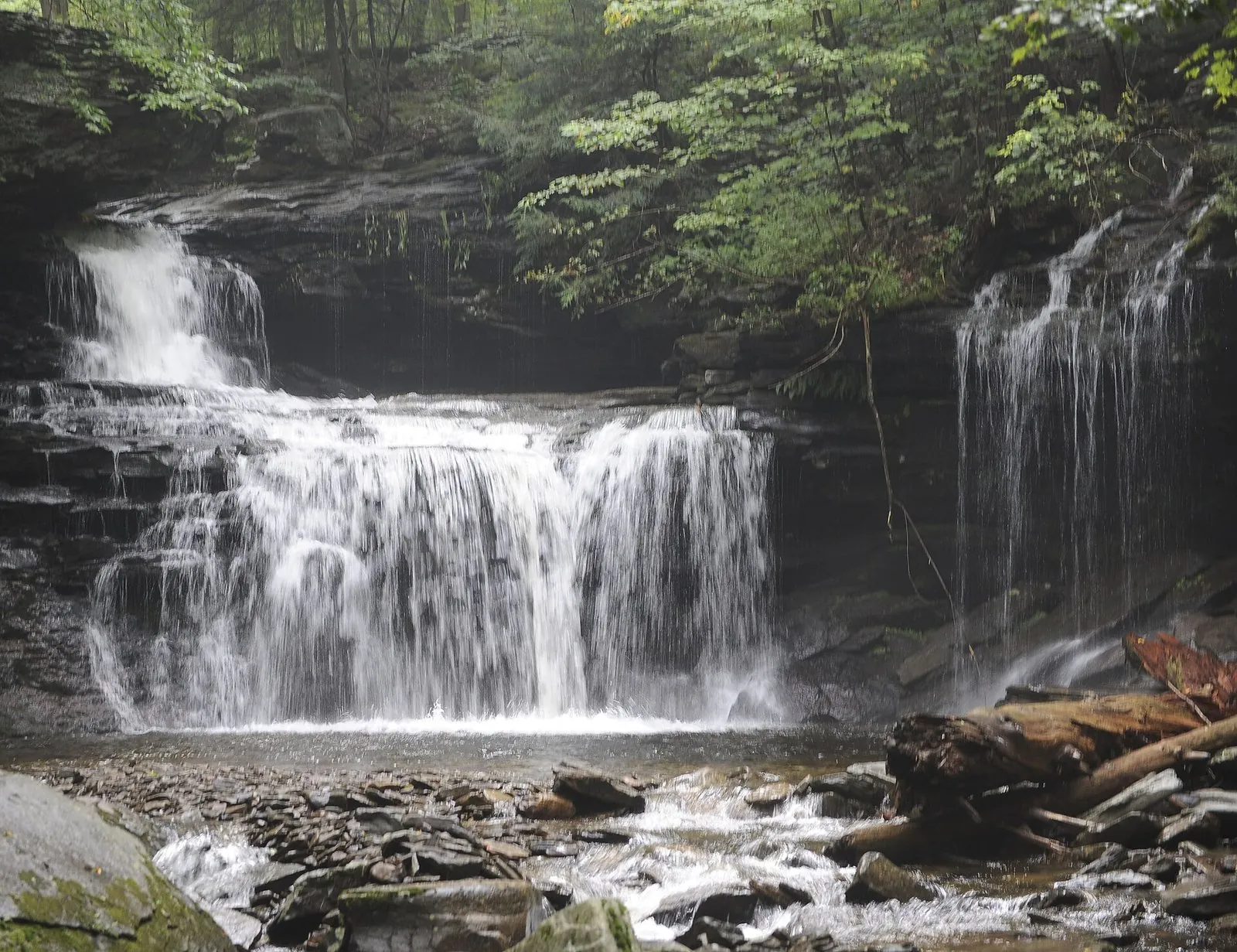 A wide, tiered waterfall spilling over layered rock ledges on the Falls Trail, among the best waterfalls in Pennsylvania