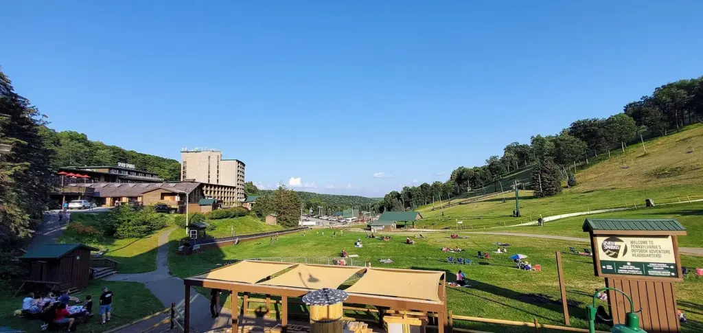 Green summer ski slopes and the hotel buildings at Seven Springs seen from the ski lodge